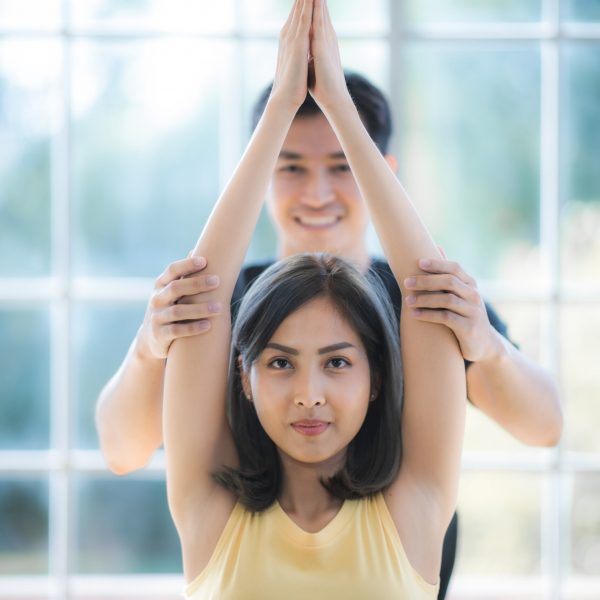young Asian couple doing Yoga to workout at home, relaxtime